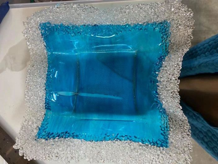 Blue textured glass dish shaped over Miracle Mesh
